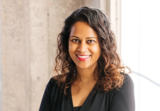 Rebecca Rodrigues smiling into at camera with an industrial background